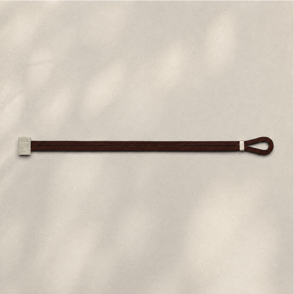 Minimal silver bracelet with brown leather cord, handmade by mugo in Italy.
